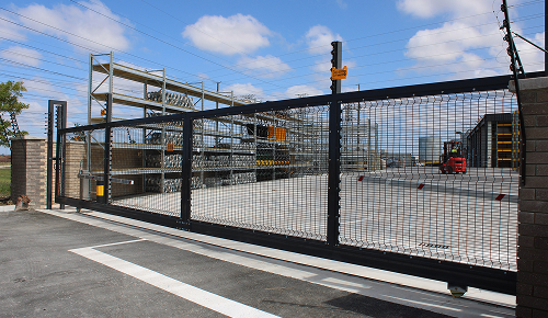 Large Automated Sliding Gate at a Factory with Electric Fences